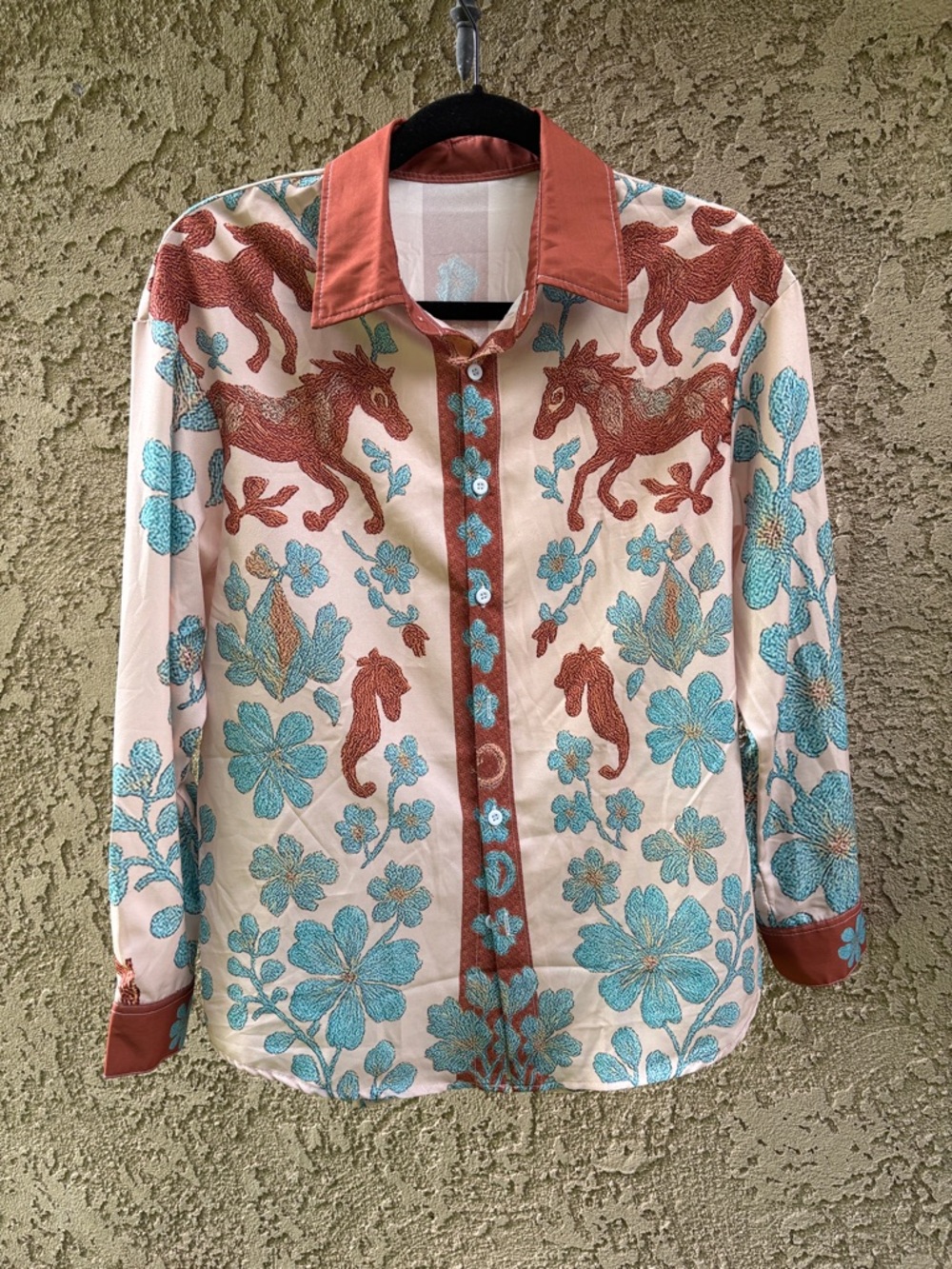 Beautiful blouse with horses and flowers .